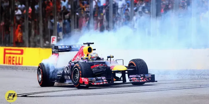 Sebastian Vettel of Germany and Infiniti Red Bull Racing performs donuts in his car after winning the Brazilian Formula One Grand Prix at Autodromo Jose Carlos Pace on November 24, 2013 in Sao Paulo, Brazil. 