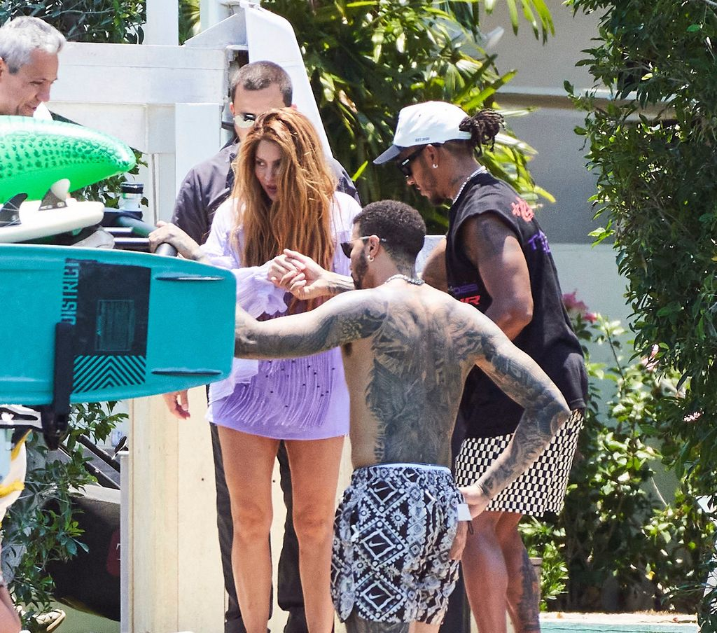 Lewis Hamilton helping Shakira join him on a boat in Miami