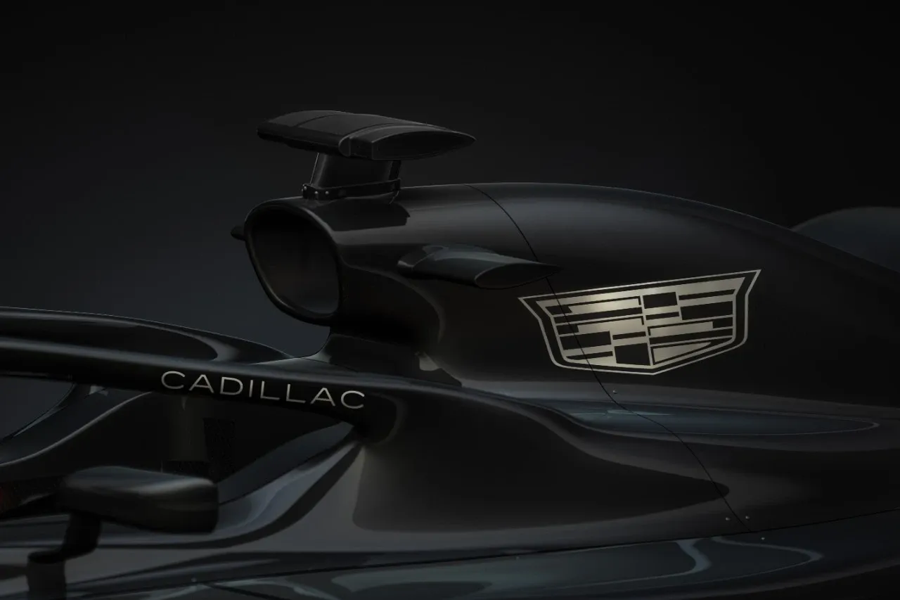 Close up 3/4 shot of black Formula 1 race car with white Cadillac logo on engine cover and halo.-Credit: GM