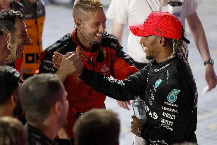 Lewis Hamilton celebrating the podium with Ferrari Mechanics at the 2023 Singapore GP  